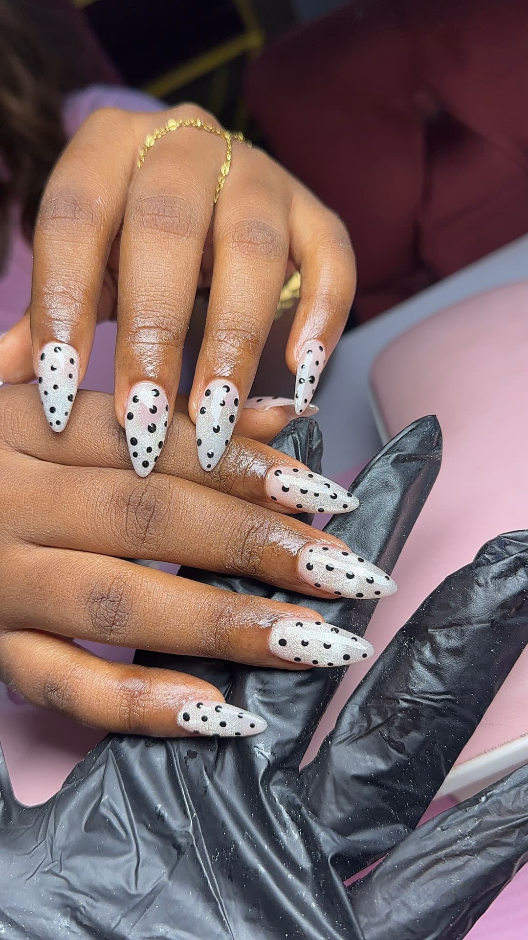 Pearl BIAB almond nails with black dot art