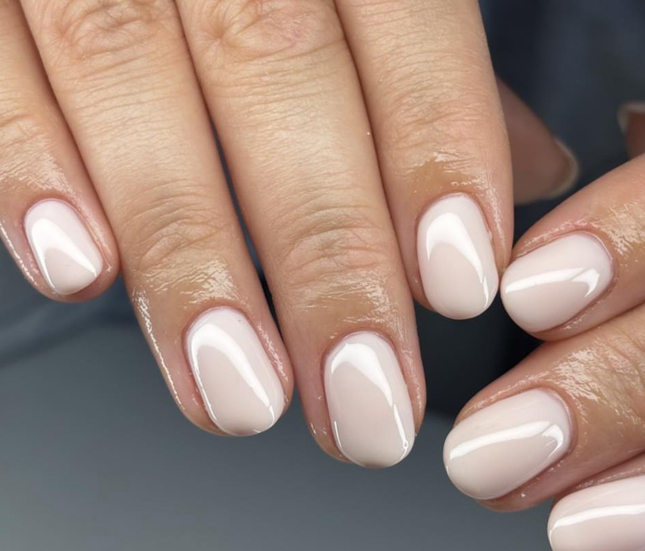 Glossy natural short BIAB nails in milky nude